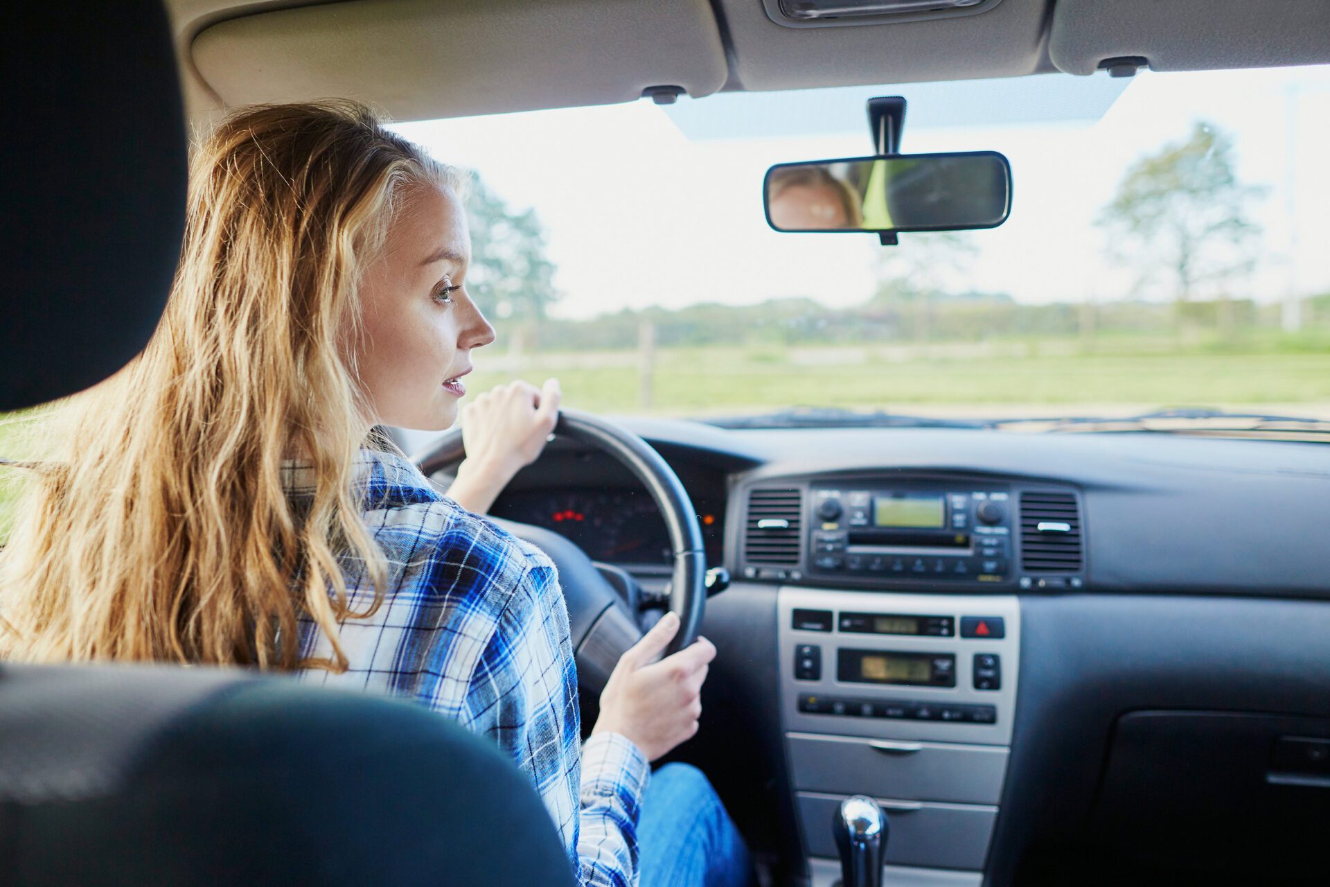 Teen girl driving car